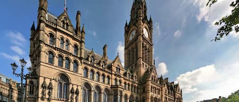 A historic building with a prominent clock tower and arched windows.