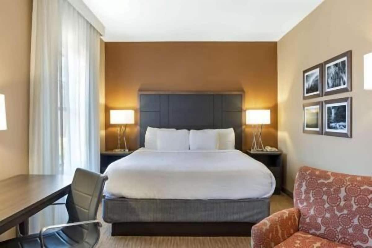 Premium bedding, desk, laptop workspace, iron/ironing board