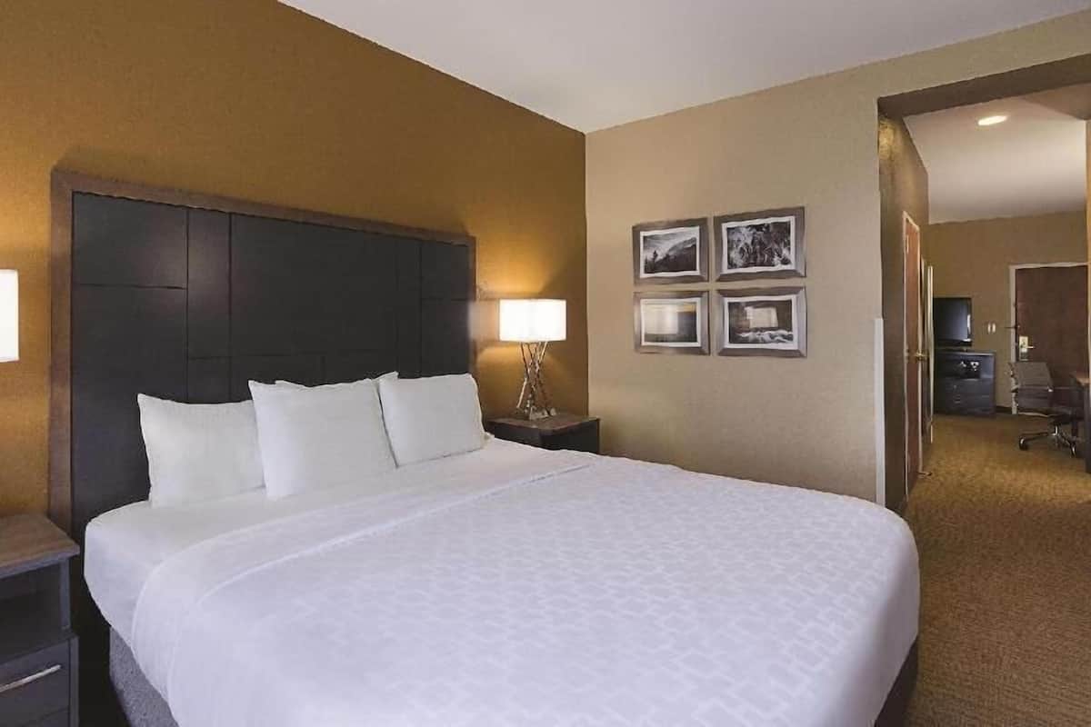 Premium bedding, desk, laptop workspace, iron/ironing board