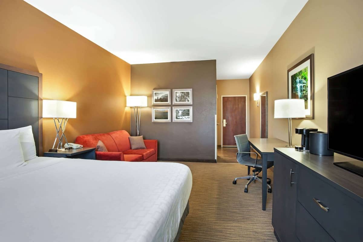 Premium bedding, desk, laptop workspace, iron/ironing board