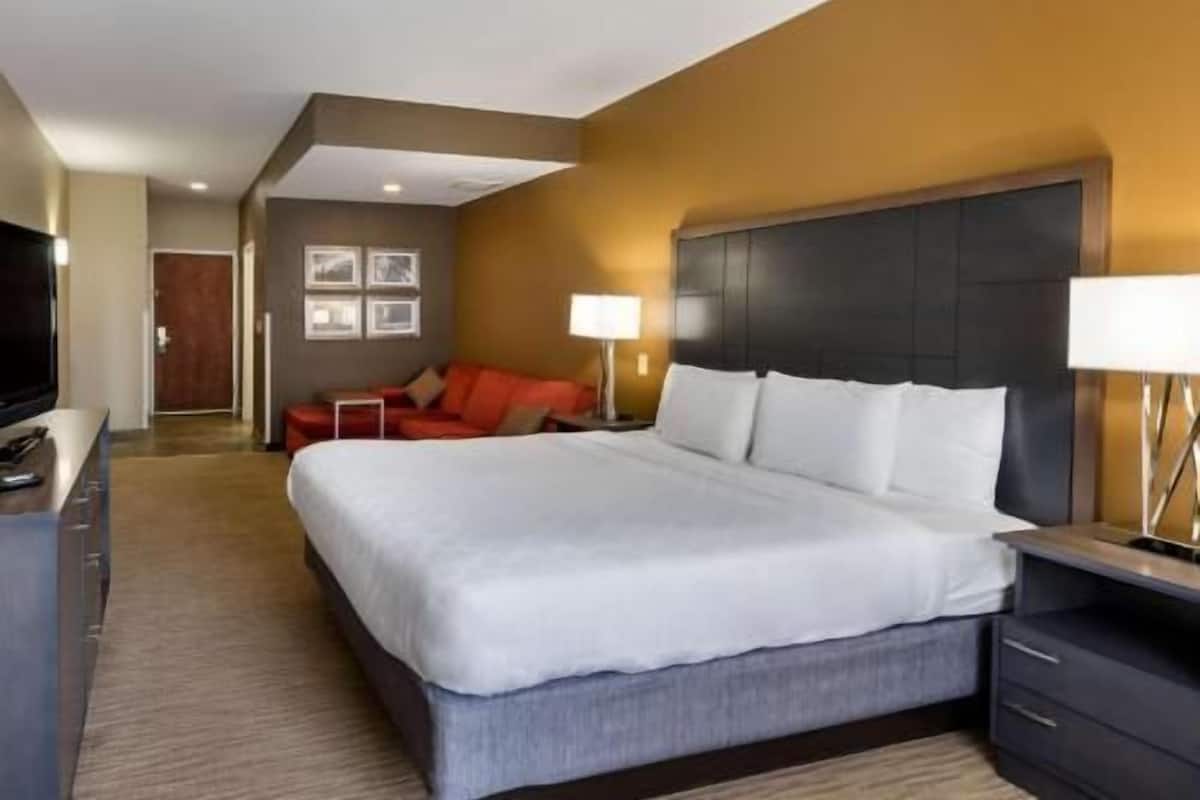Premium bedding, desk, laptop workspace, iron/ironing board