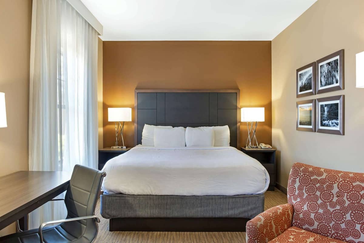 Premium bedding, desk, laptop workspace, iron/ironing board