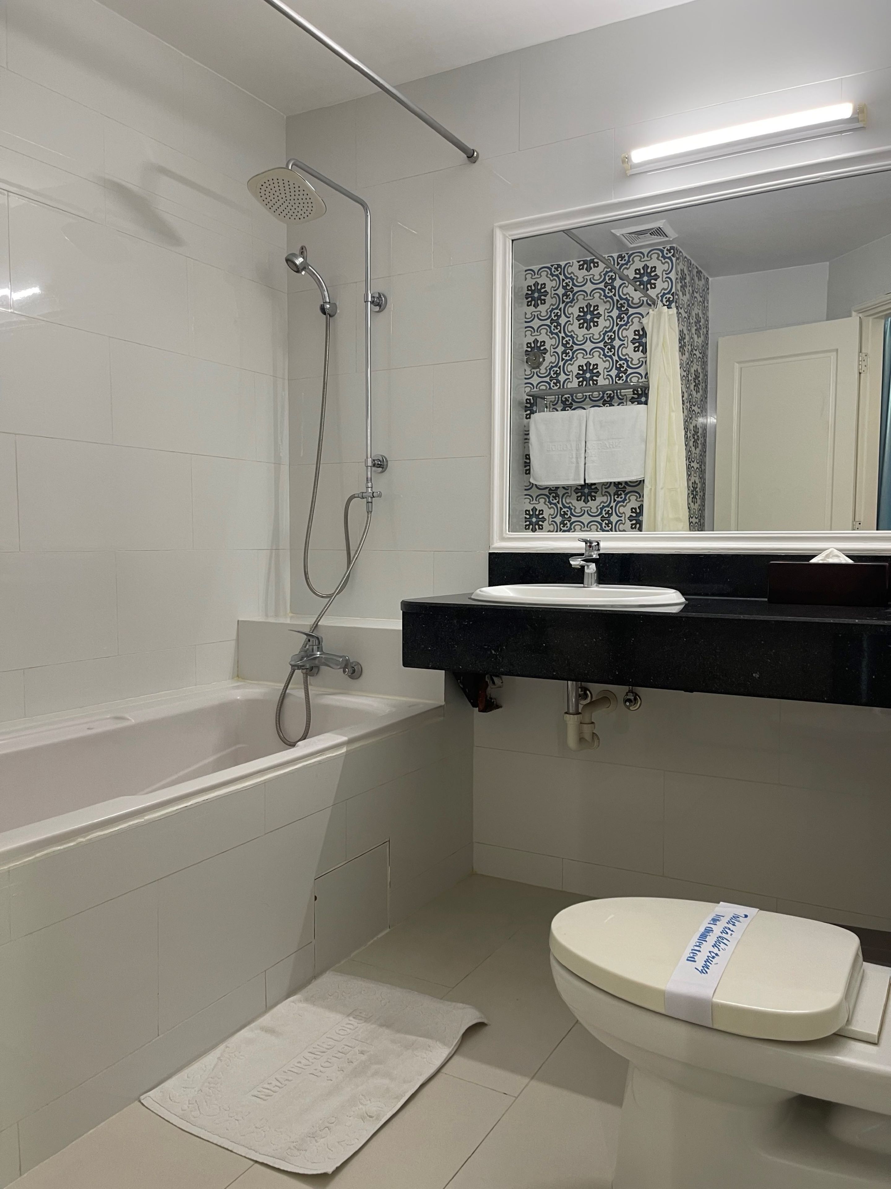 A bathroom with a bathtub, a shower, a toilet, and a sink.