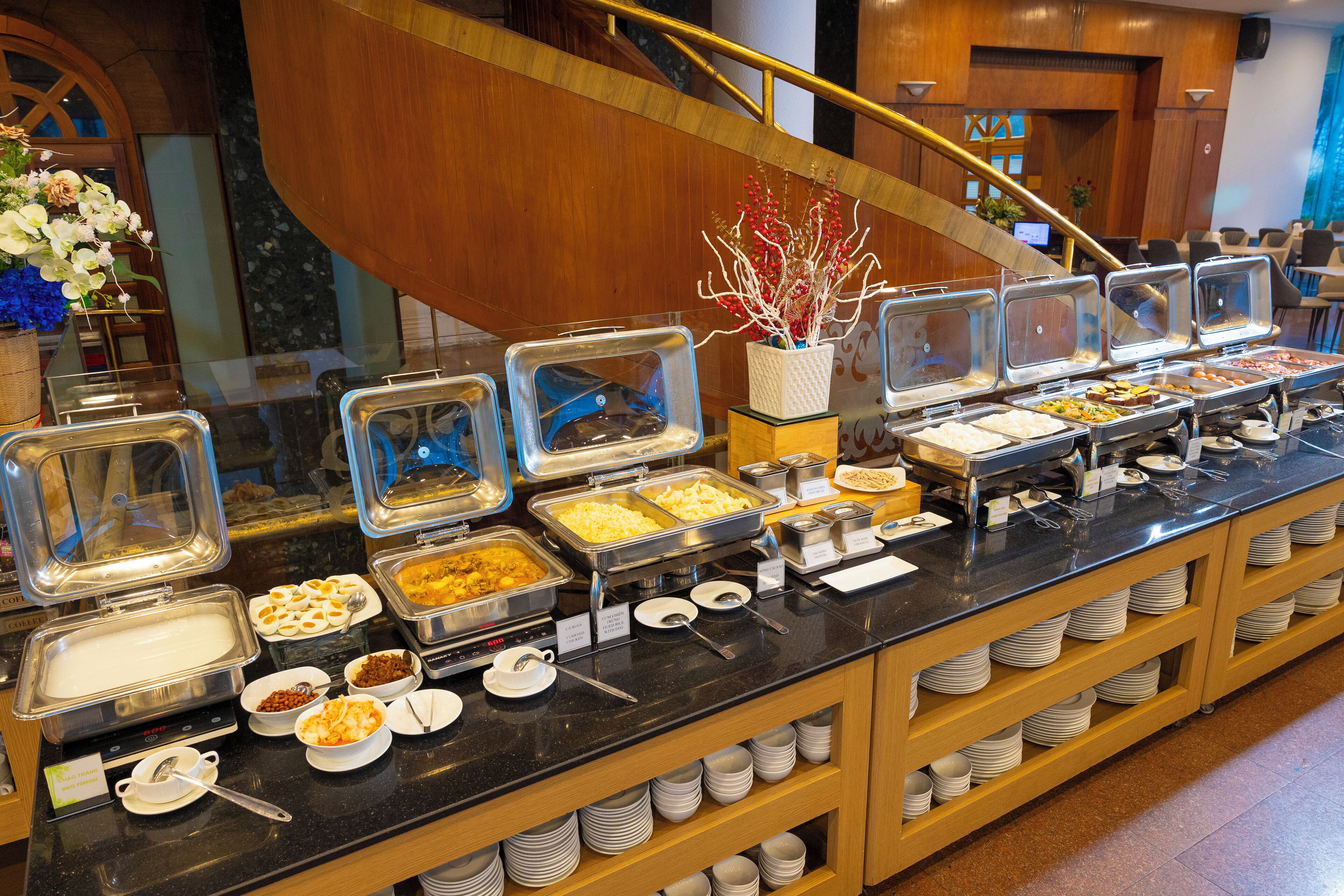A buffet with various food items and serving utensils.