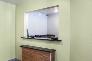 A bathroom with a vanity, a mirror, and a shower area. - WoodSpring Suites Corpus Christi (Corpus Christi)