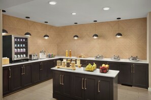 A modern kitchen with dark cabinets, a central island, and pendant lighting. - Residence Inn by Marriott San Diego Oceanside (Oceanside)