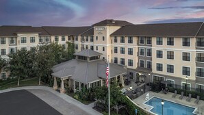 A hotel with a pool, outdoor seating, and a covered patio area. - Residence Inn by Marriott San Diego Oceanside (Oceanside)