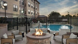 A poolside area with a fire pit, outdoor seating, and a view of a swimming pool. - Residence Inn by Marriott San Diego Oceanside (Oceanside)