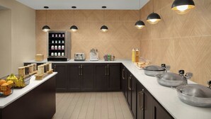 A modern kitchen with dark cabinets, a white countertop, and a herringbone-patterned backsplash. - Residence Inn by Marriott San Diego Oceanside (Oceanside)