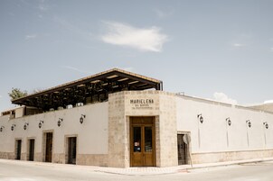 A building with a sign reading "MARIELENA HOTEL RESTAURANTE".