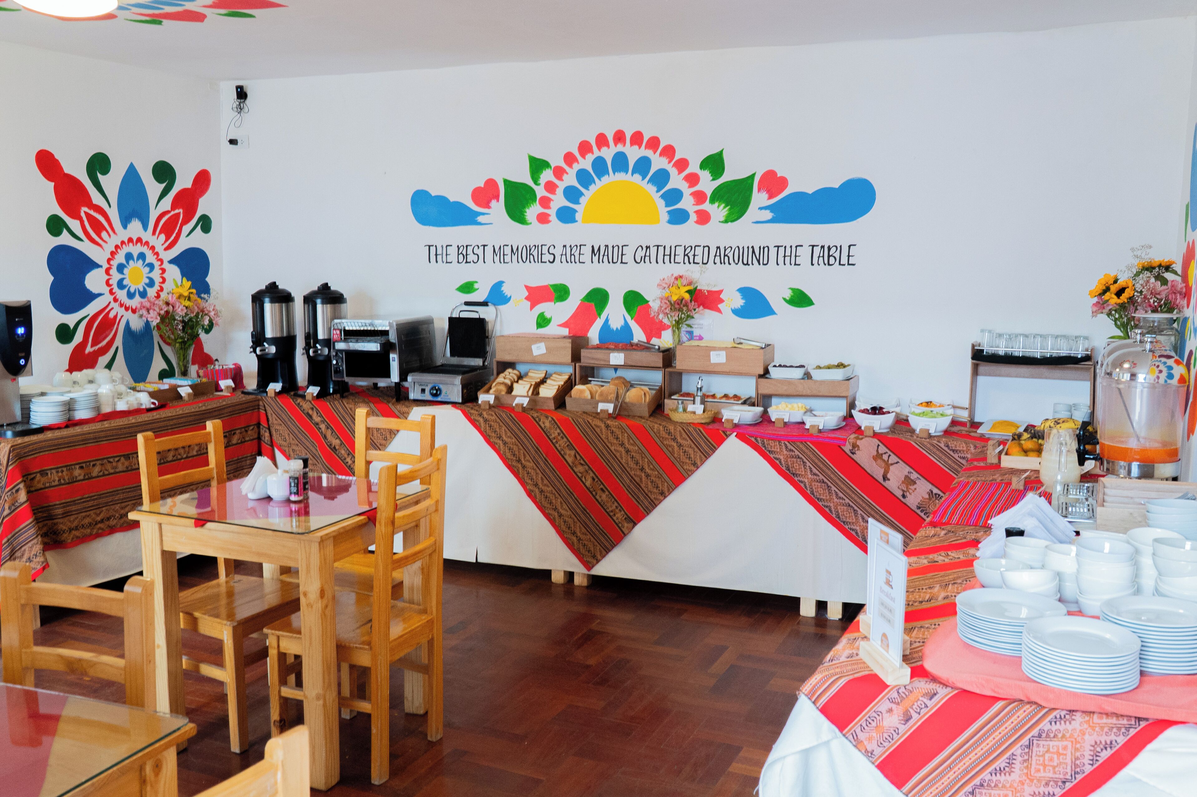 A dining area with a buffet setup, including a coffee station and various food items.