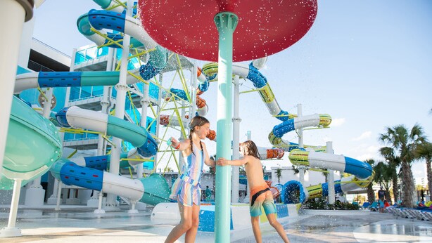 A water park with multiple water slides and a large water fountain. - Palace Resort (Myrtle Beach)