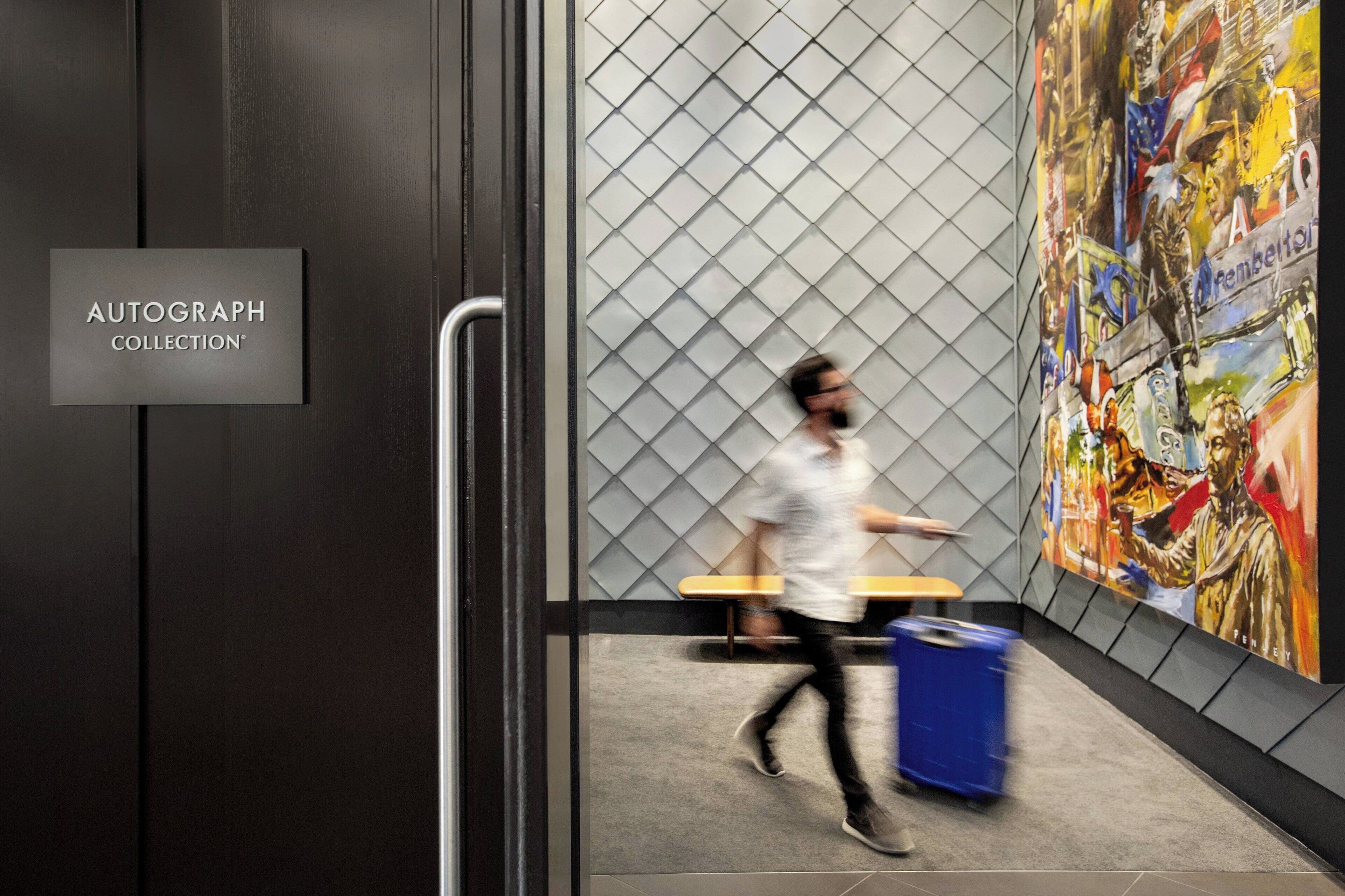 A modern interior with a sign reading "AUTOGRAPH COLLECTION".