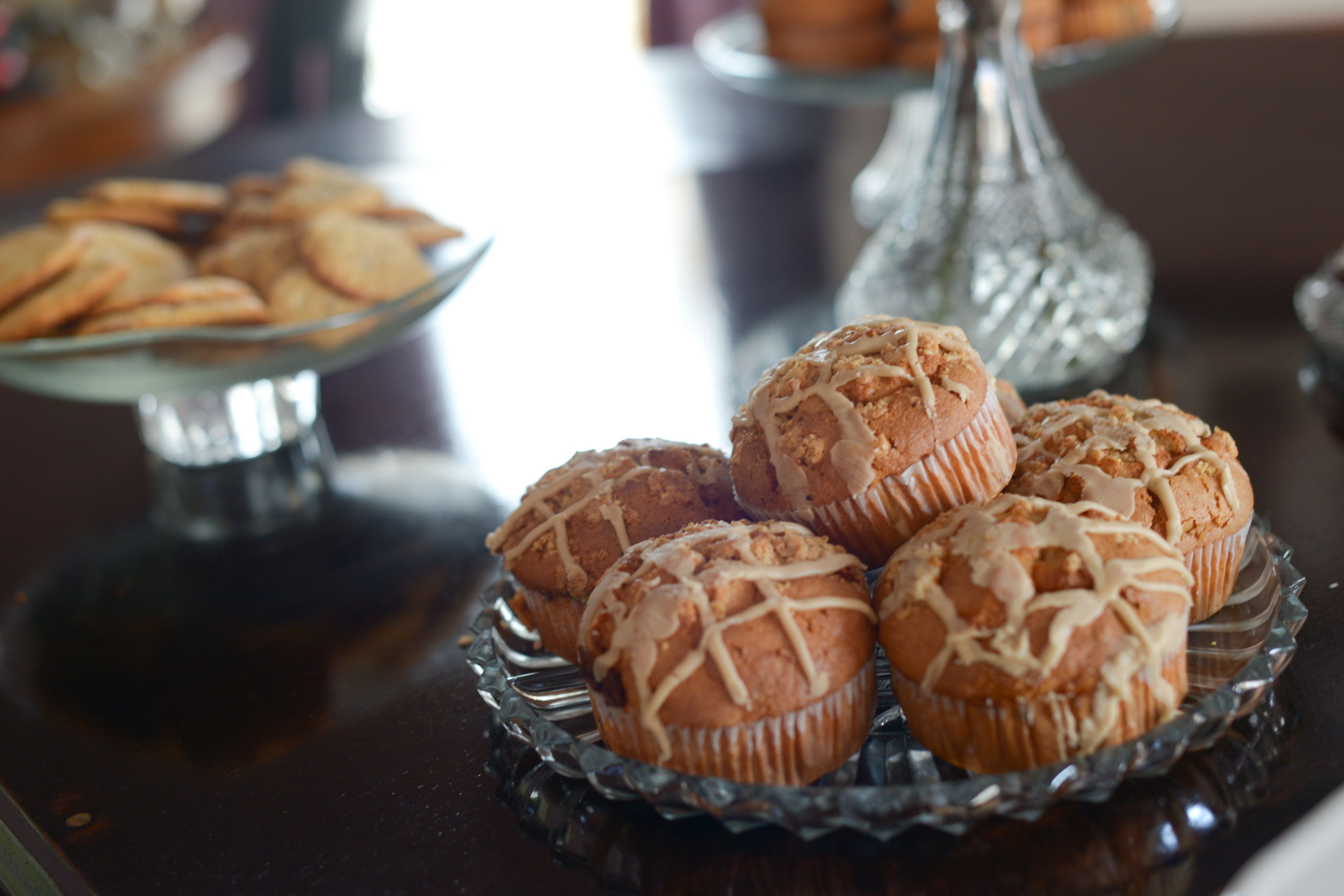 A glass serving tray with muffins and cookies.