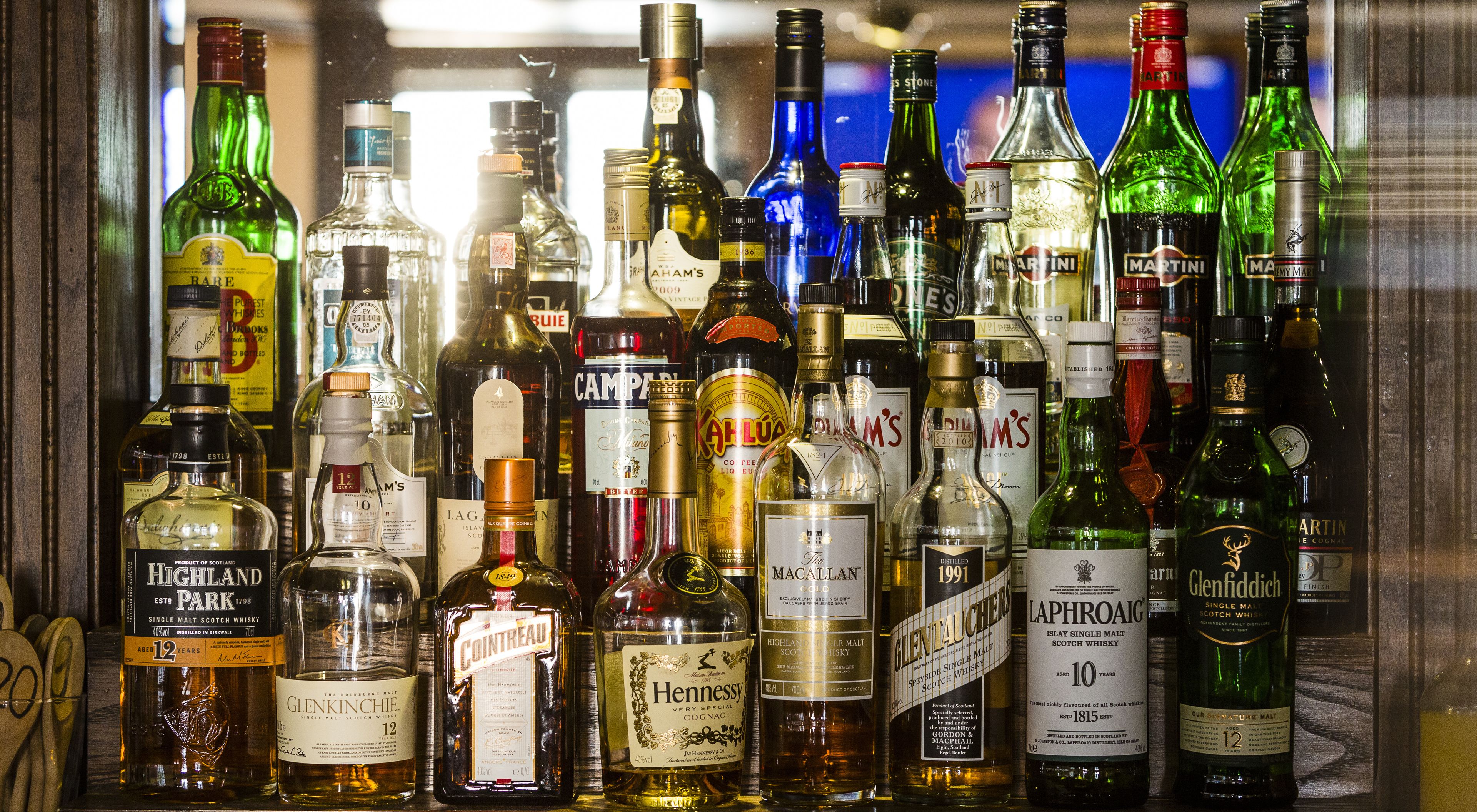 Variedad de botellas de licor exhibidas en una vitrina.