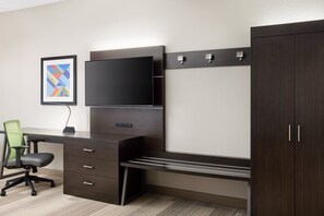 A modern office space with a desk, chair, TV, and wardrobe. - Holiday Inn Express & Suites Seymour by IHG (Seymour)