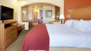 A hotel room with a large bed, a television, a desk, and a kitchenette. - Holiday Inn Express & Suites Zapata by IHG (Zapata)