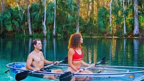 Two people in a kayak on a calm body of water surrounded by dense greenery. - Holiday Inn Express Hotel & Suites Silver Springs - Ocala by IHG (Silver Springs)