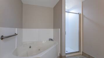 A bathroom with a bathtub, a shower, and a toilet.