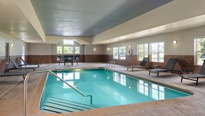 An indoor swimming pool with a tiled floor, a pool ladder, and lounge chairs around the pool. - Residence Inn by Marriott Mt. Laurel at Bishop's Gate (Mount Laurel)