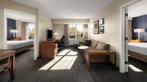 A hotel room with a bed, desk, chair, sofa, and TV. - Residence Inn by Marriott Mt. Laurel at Bishop's Gate (Mount Laurel)