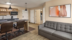 A modern apartment with a kitchen, dining area, and living room. - Candlewood Suites Augusta by IHG (Augusta)