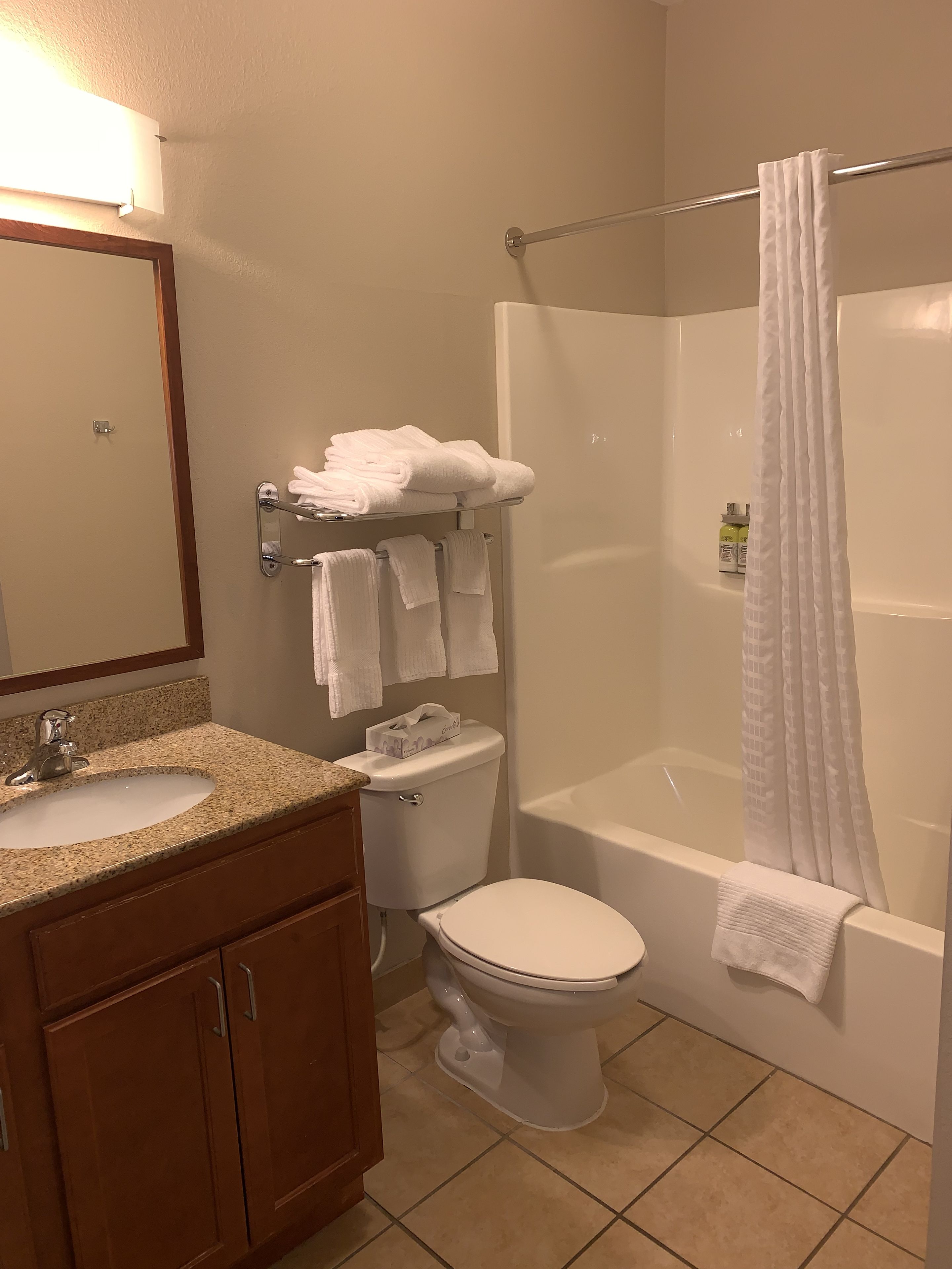 studio suite | premium bedding, desk, laptop workspace, blackout curtains