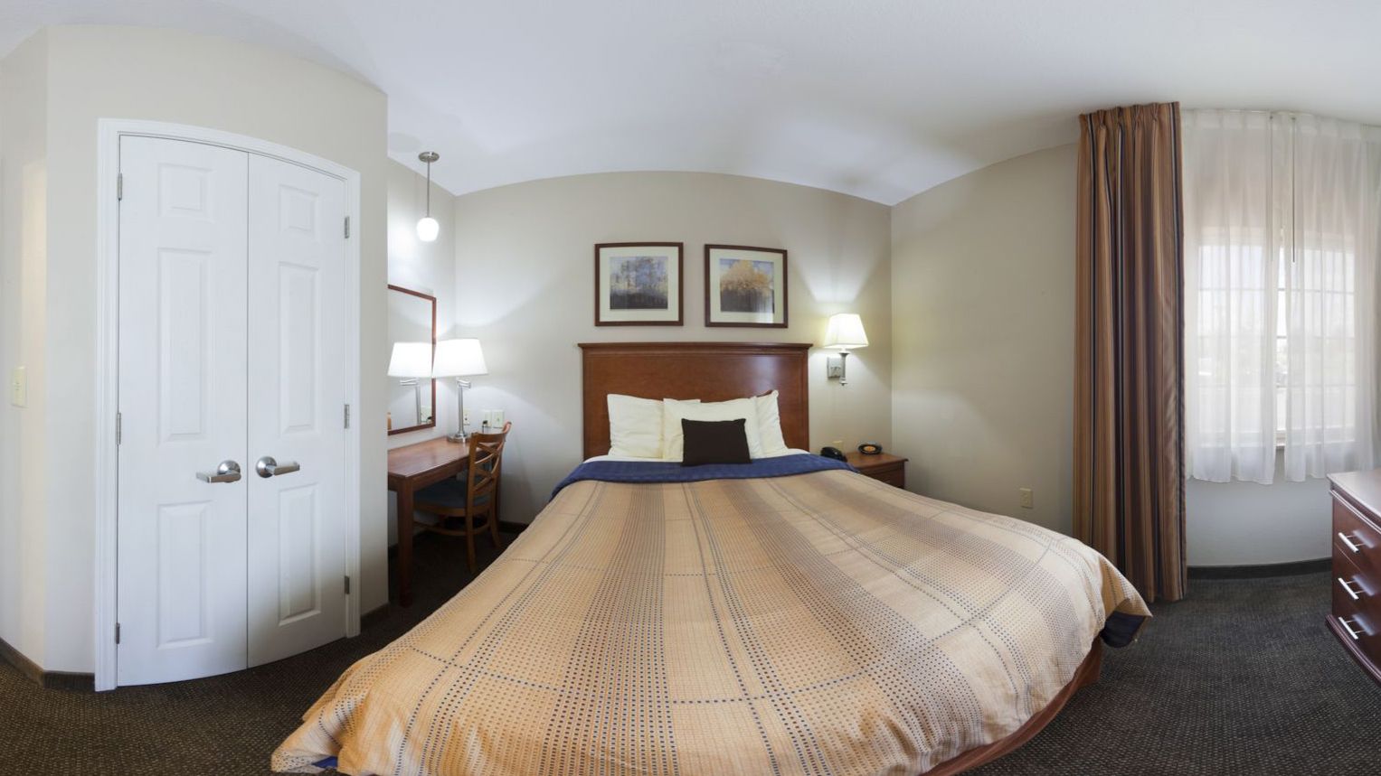 studio suite | premium bedding, desk, laptop workspace, blackout curtains