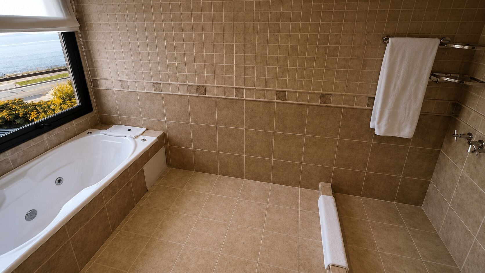 Un baño con bañera, ventana con vistas y un perchero.
