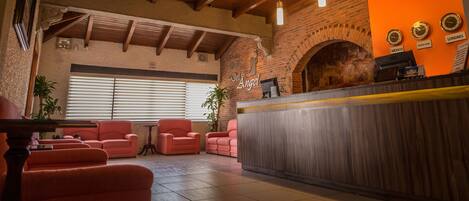 Experience the warm and inviting lobby of Hotel Del Angel, where guests can relax and unwind in a comfortable and functional space.