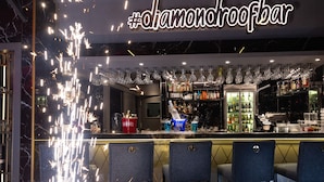 A bar area with a sign reading "#diamondroofbar", bar stools, shelves with bottles, and a sparkling effect on the ceiling. - Hotel Grand Washington (Istanbul)