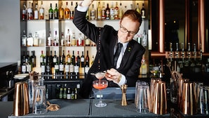 A bartender pouring a drink into a martini glass. - Malmaison Brighton (Brighton)