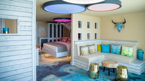 A bedroom with a bed, a sofa, and a decorative wall with a skull. - Malmaison Brighton (Brighton)