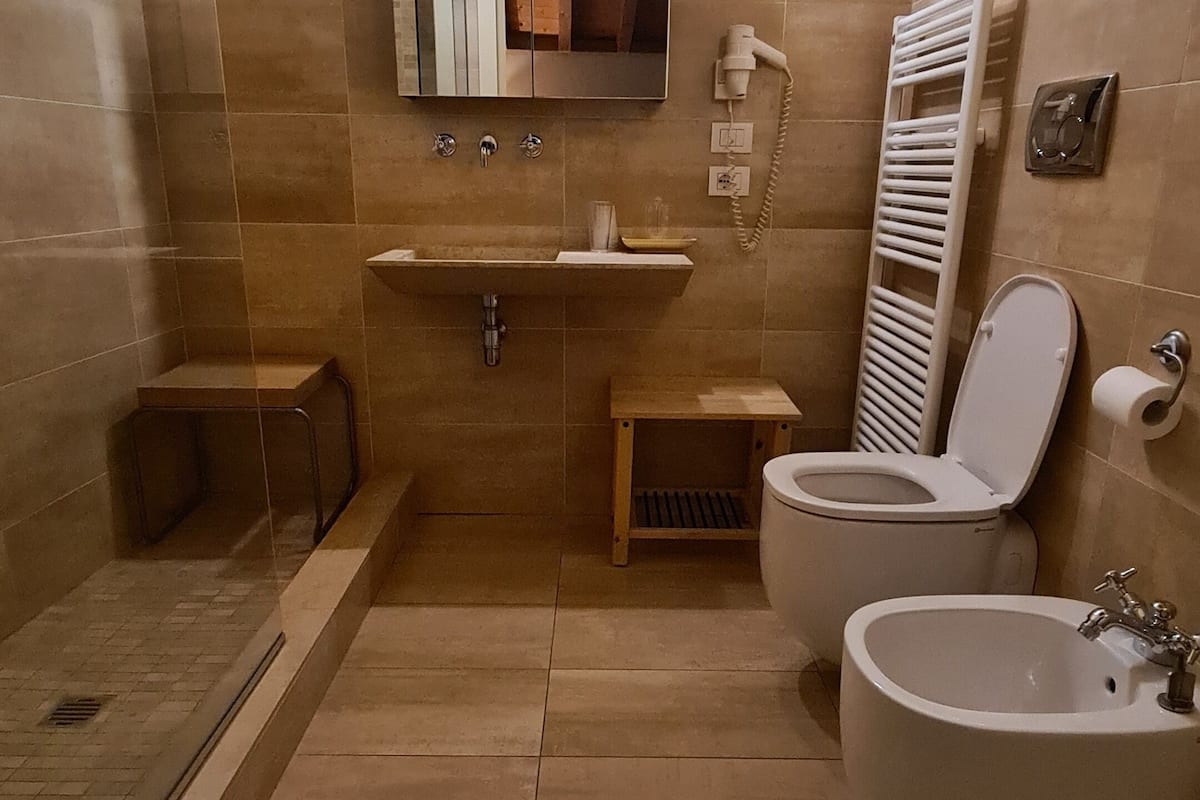 superior twin room | bathroom | shower, rainfall showerhead, designer toiletries, hair dryer