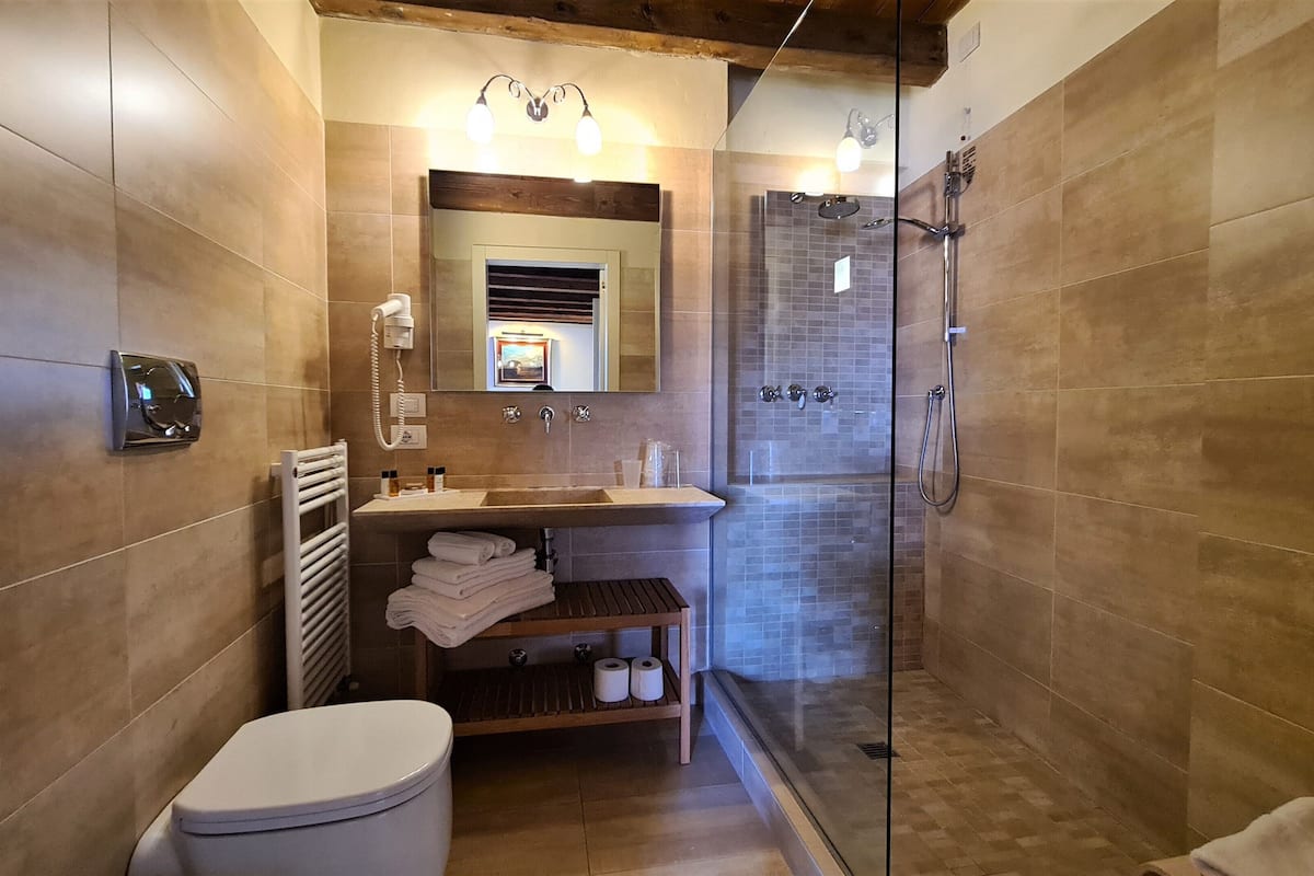 deluxe double room | bathroom | shower, rainfall showerhead, designer toiletries, hair dryer