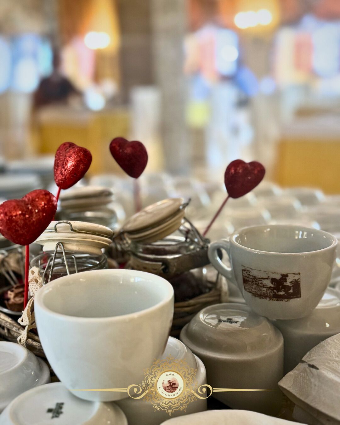 A collection of white ceramic dishes and a cup with a vintage design, surrounded by heart-shaped decorations.