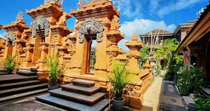 A traditional Balinese temple with intricate carvings and a clear sky. - Stana Puri Gopa Hotel (Denpasar)