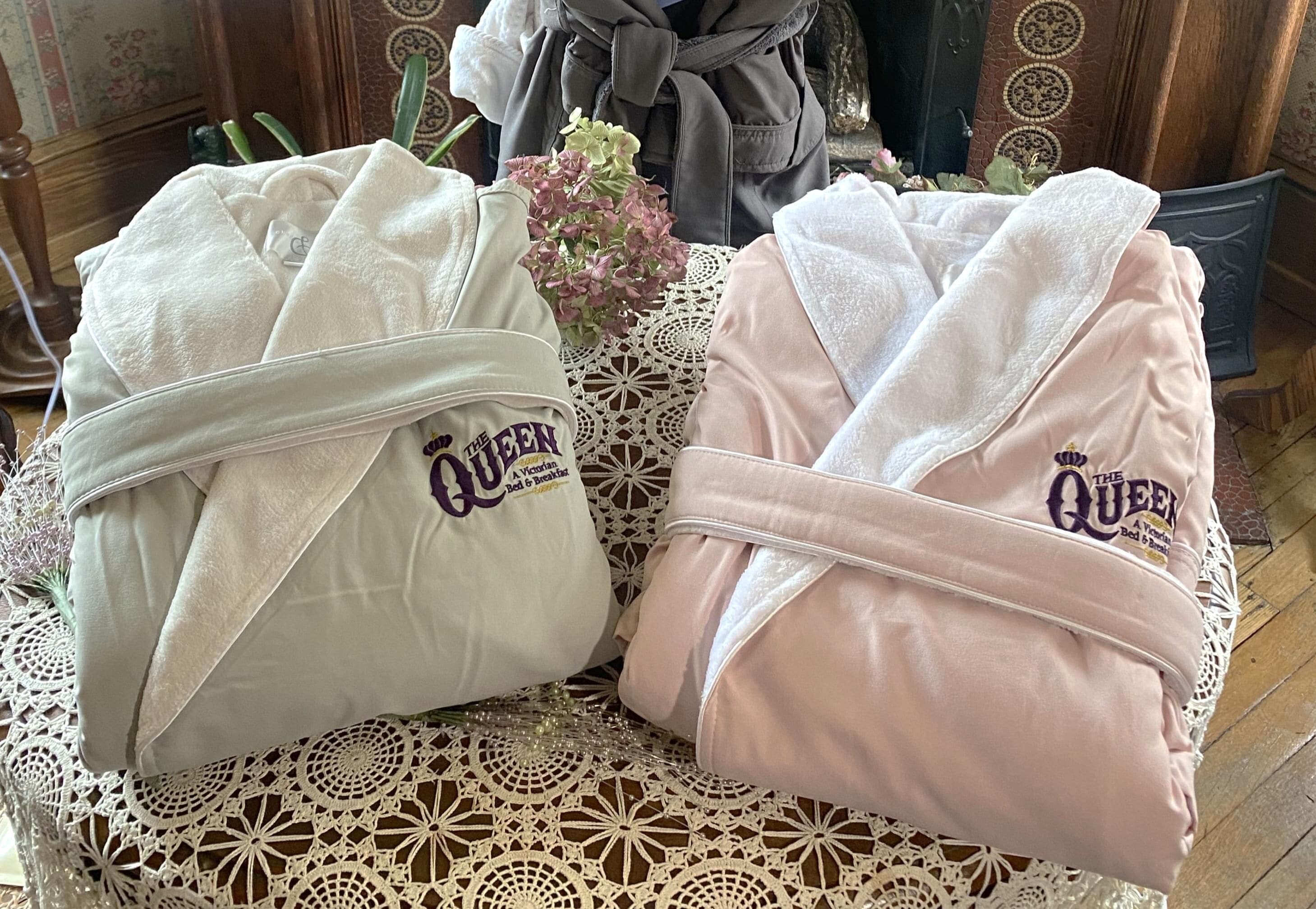 Two towels with "The Queen" branding on a table.