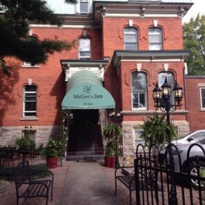 A brick building with a green awning labeled "McGee's Inn."