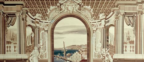 An ornate architectural archway with classical design elements, including columns and decorative moldings.