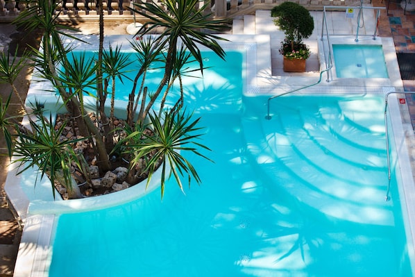 Seasonal outdoor pool, open 10:00 AM to 6:00 PM, pool umbrellas