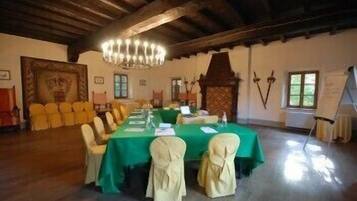 A conference room with a long table, chairs, and a chandelier.
