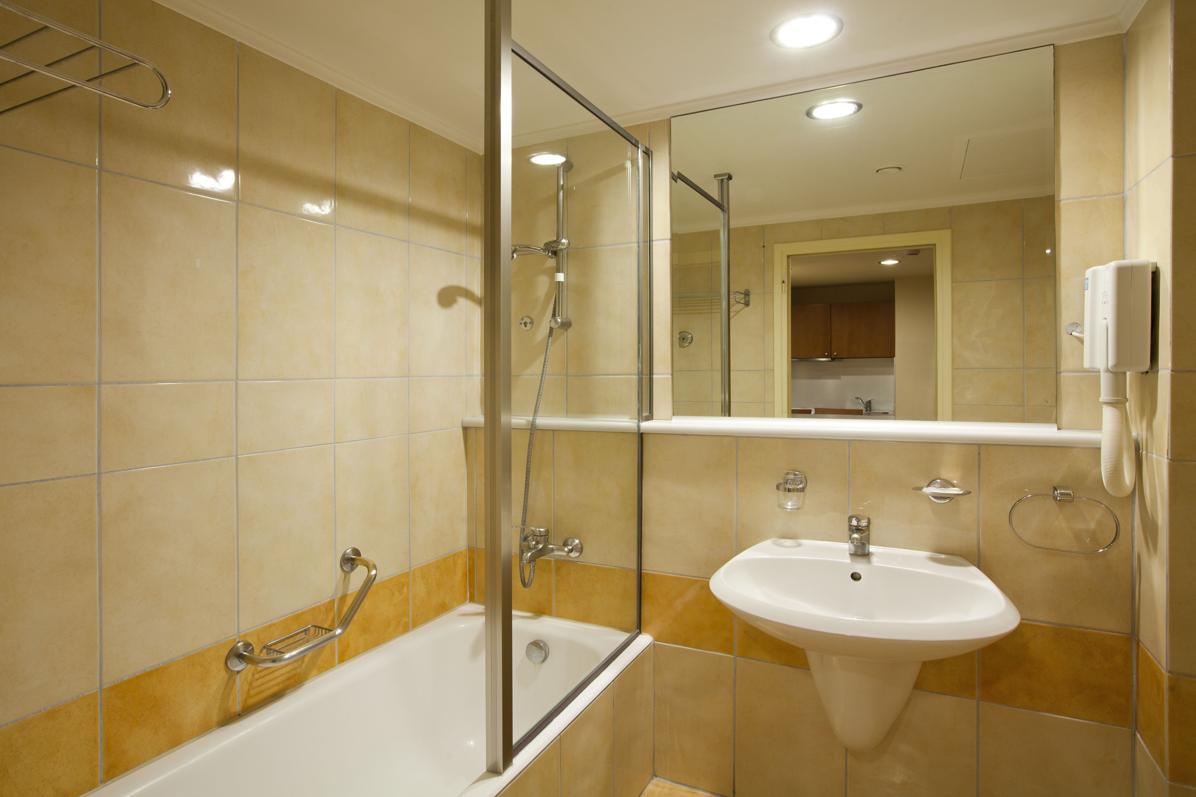A modern bathroom with a bathtub, a sink, and a shower.