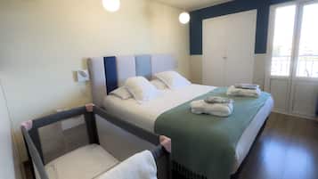 Relax in a stylishly designed room with a comfortable bed, plush towels, and a cozy throw blanket.
