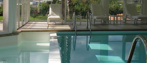 Indoor pool, open 8:00 AM to 8:00 PM, pool loungers