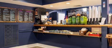 A Bartlett New Hampshire restaurant interior with a dark blue theme, a menu board, and a coffee machine.