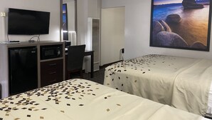 A hotel room with two beds, a desk, a television, and a large window with a scenic view. - High Country Lodge (South Lake Tahoe)