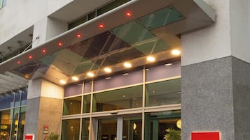 The exterior of the Leonardo Hotels building with a modern design, large glass windows, and prominent signage.