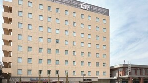 A multi-story hotel building with a flat facade, numerous windows, and a sign indicating it is the 'East Hotel Mets.' - Hotel Mets Fukushima (Fukushima)