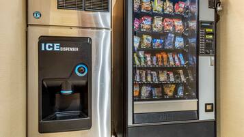 A vending machine with a beverage dispenser and a snack vending area.
